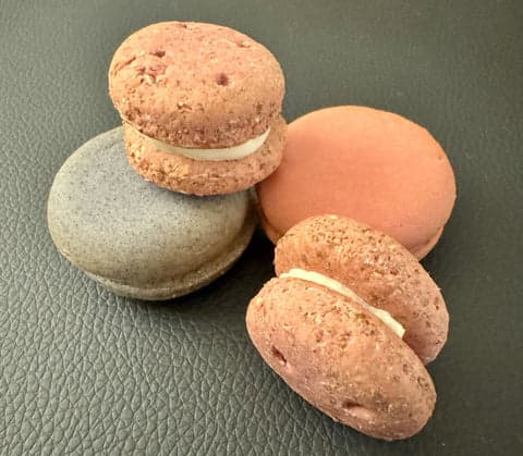red and dark green dog macarons with white filling